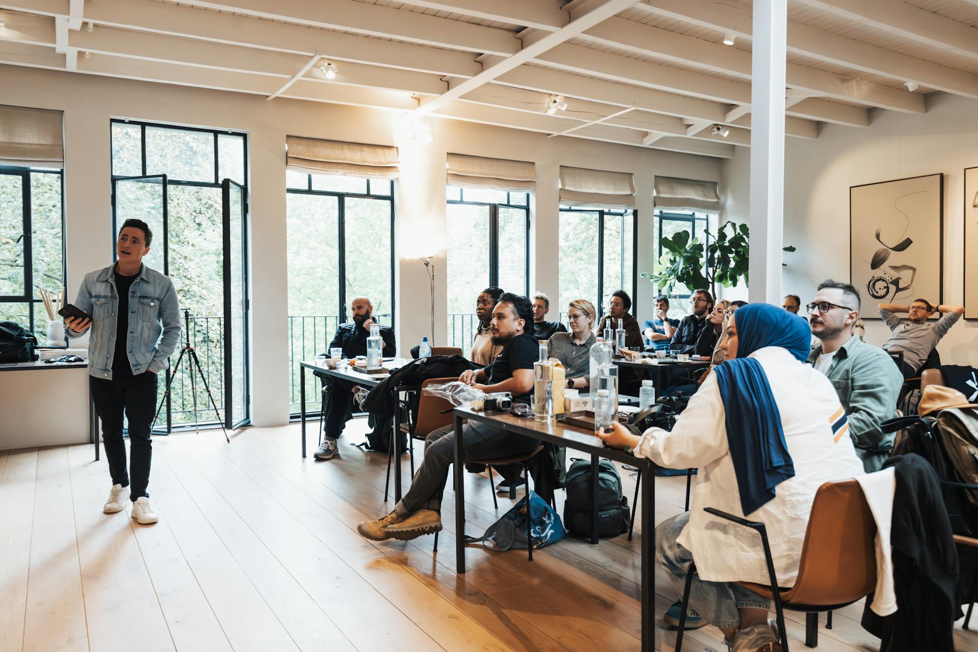 Participants attending a cybersecurity and safety workshop, listening to a speaker and viewing a presentation on digital security.
